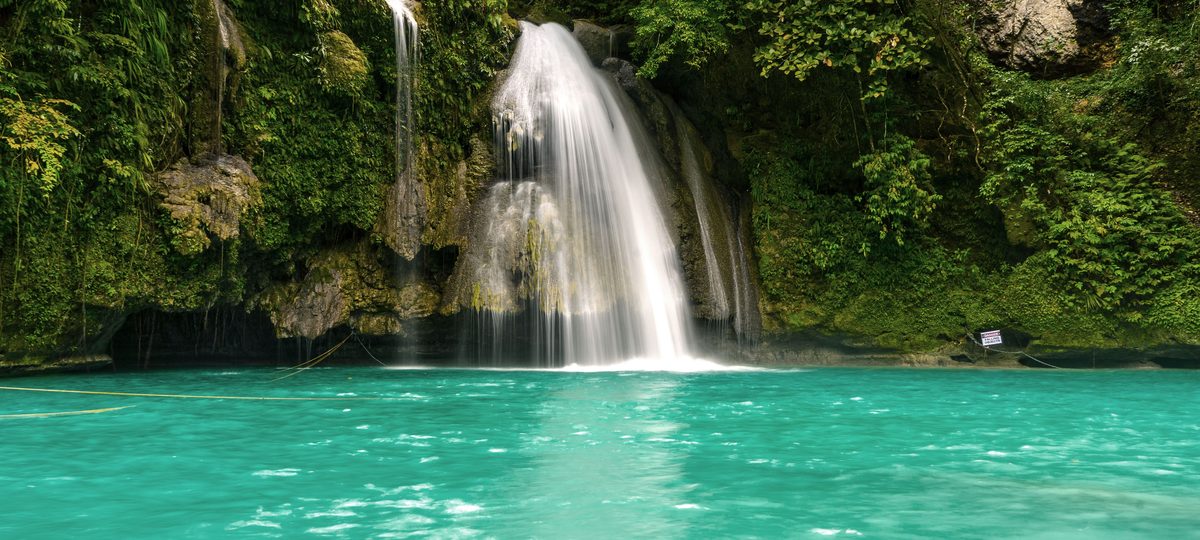 Kawasan Falls spilling into a turquoise pool in Cebu.